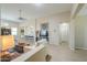 Living room features tile floors, comfortable seating, ceiling fan, and stylish decor with a kitchen bar in the background at 60 S Agua Fria Ln, Casa Grande, AZ 85194