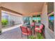 Charming covered patio with red cushioned seating, ideal for enjoying the outdoors at 60 S Agua Fria Ln, Casa Grande, AZ 85194