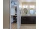 Walk-in closet with built-in shelving, connecting to the main bathroom with dual sinks at 60 S Agua Fria Ln, Casa Grande, AZ 85194