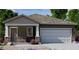 Charming single-story home featuring a stone-accented facade, a two-car garage, and a well-maintained lawn at 6050 E Artemis Dr, Florence, AZ 85132