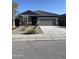 Well-maintained single-story home with a two-car garage and a gray exterior paint at 6113 E Artemis Dr, Florence, AZ 85132
