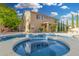 Inviting backyard featuring a pool, spa, mature landscaping, and a well-maintained lawn at 6961 W Honeysuckle Dr, Peoria, AZ 85383
