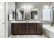 Elegant bathroom featuring double sinks, mirrors, and cabinetry at 6961 W Honeysuckle Dr, Peoria, AZ 85383