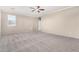 Large empty bedroom featuring neutral carpet, neutral paint, and a ceiling fan at 6961 W Honeysuckle Dr, Peoria, AZ 85383