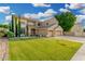 Beautifully landscaped home with a green lawn, mature trees, and a spacious three-car garage at 6961 W Honeysuckle Dr, Peoria, AZ 85383