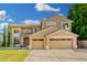 Well-maintained two-story home with a three-car garage and manicured lawn at 6961 W Honeysuckle Dr, Peoria, AZ 85383