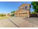 Beautiful two-story home with a well-kept lawn, desert landscaping, and a three-car garage at 6961 W Honeysuckle Dr, Peoria, AZ 85383