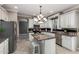 Spacious kitchen featuring granite countertops, white cabinets, and stainless steel appliances at 6961 W Honeysuckle Dr, Peoria, AZ 85383