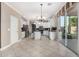 Spacious kitchen with a granite center island, white cabinetry, stainless steel appliances, and sliding glass doors to the yard at 6961 W Honeysuckle Dr, Peoria, AZ 85383