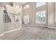 Open-concept living area featuring soaring ceilings, a staircase, neutral carpet, and an abundance of natural light at 6961 W Honeysuckle Dr, Peoria, AZ 85383