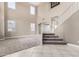Large living room with a staircase, soaring ceilings, neutral carpet, and ample natural light from multiple windows at 6961 W Honeysuckle Dr, Peoria, AZ 85383