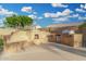 Built-in outdoor kitchen featuring a gas grill, fridge, and fireplace on patio at 6961 W Honeysuckle Dr, Peoria, AZ 85383