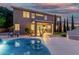 Night view of a private pool and backyard oasis with lush landscaping at 6961 W Honeysuckle Dr, Peoria, AZ 85383