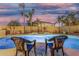 Relaxing poolside setting with chairs, a spa, and mature palm trees at 6961 W Honeysuckle Dr, Peoria, AZ 85383