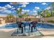 Inviting pool area complete with chairs, landscaping, and a clear view of the surrounding yard at 6961 W Honeysuckle Dr, Peoria, AZ 85383