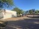 Spacious backyard featuring a full basketball court with a storage shed and a secure fence at 7044 E Ann Way, Scottsdale, AZ 85254