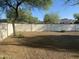 Desert landscaping surrounding the backyard is highlighted by a high privacy fence at 7044 E Ann Way, Scottsdale, AZ 85254