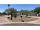 Charming single-story home with desert landscaping, mature trees, and a circular driveway enhancing curb appeal at 7044 E Ann Way, Scottsdale, AZ 85254