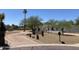 Charming single-story home boasts well-maintained landscaping, mature trees, and circular driveway enhancing curb appeal at 7044 E Ann Way, Scottsdale, AZ 85254