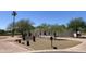 Beautiful home featuring a circular driveway, well-maintained desert landscaping, and mature trees for added privacy at 7044 E Ann Way, Scottsdale, AZ 85254