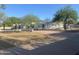 Stunning home featuring a meticulously maintained front yard with mature trees and a circular driveway at 7044 E Ann Way, Scottsdale, AZ 85254