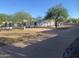 Stunning home featuring a meticulously maintained front yard with mature trees and a circular driveway at 7044 E Ann Way, Scottsdale, AZ 85254