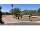 Single-story home with mature trees and a circular driveway creating an inviting entry and enhancing curb appeal at 7044 E Ann Way, Scottsdale, AZ 85254