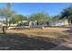 Stunning home featuring a meticulously maintained front yard with mature trees and a circular driveway at 7044 E Ann Way, Scottsdale, AZ 85254