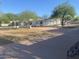 Stunning home featuring a meticulously maintained front yard with mature trees and a circular driveway at 7044 E Ann Way, Scottsdale, AZ 85254