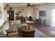 Inviting living room featuring a cozy fireplace, tiled floors and comfortable seating area at 7044 E Ann Way, Scottsdale, AZ 85254