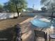 Back yard features a sparkling pool with fountains, lounge area, and a white privacy fence at 7044 E Ann Way, Scottsdale, AZ 85254