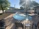 Back yard features a sparkling pool with fountains, lounge area, and a white privacy fence at 7044 E Ann Way, Scottsdale, AZ 85254