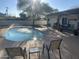 Back yard features a sparkling pool with fountains, outdoor lounge, and covered patio at 7044 E Ann Way, Scottsdale, AZ 85254