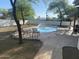 Enjoy this sparkling pool with a rock border, a lounge area, and beautiful trees at 7044 E Ann Way, Scottsdale, AZ 85254