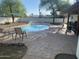 Sparkling pool with fountains, lounge area, umbrellas, and concrete patio at 7044 E Ann Way, Scottsdale, AZ 85254