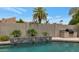 Beautiful backyard featuring a custom pool, a lush landscape, and a built-in grill for great outdoor living at 7806 E Via De La Entrada --, Scottsdale, AZ 85258