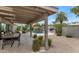 Covered patio area with seating and a view of the pool and lush landscaping, perfect for outdoor enjoyment at 7806 E Via De La Entrada --, Scottsdale, AZ 85258