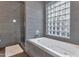 Modern tiled bathroom with a large soaking tub and separate glass enclosed shower at 7806 E Via De La Entrada --, Scottsdale, AZ 85258