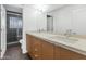 Bathroom features a double sink vanity, light countertops, wood cabinets, and glass block shower at 7806 E Via De La Entrada --, Scottsdale, AZ 85258