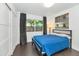 A modern bedroom featuring dark wood floors, a large window, and minimalist decor for a clean, stylish look at 7806 E Via De La Entrada --, Scottsdale, AZ 85258