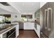 Bright kitchen with stainless steel appliances, dark wood floors, and a view to the backyard at 7806 E Via De La Entrada --, Scottsdale, AZ 85258