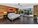Modern main bedroom with wood accent wall, ceiling fan and private pool view at 7806 E Via De La Entrada --, Scottsdale, AZ 85258