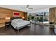 Modern main bedroom boasts wood accent wall, ceiling fan, and sliding doors to the pool at 7806 E Via De La Entrada --, Scottsdale, AZ 85258