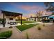 Expansive backyard features a covered patio, lush lawn, and outdoor bar, perfect for entertaining at 8001 E Voltaire Ave, Scottsdale, AZ 85260