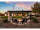 Relaxing backyard with a fire pit, outdoor seating, and a TV with a picturesque landscape, perfect for entertaining at 8001 E Voltaire Ave, Scottsdale, AZ 85260