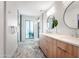 Bright bathroom features dual vanity, hexagon tile floor, and glass-enclosed shower with white subway tile at 8001 E Voltaire Ave, Scottsdale, AZ 85260