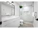 Modern bathroom boasts a glass-enclosed shower with marble-look tile and a sleek, floating vanity at 8001 E Voltaire Ave, Scottsdale, AZ 85260