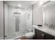 Updated bathroom featuring tiled walk-in shower, built-in shelves, and a dark wood vanity at 8001 E Voltaire Ave, Scottsdale, AZ 85260