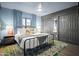 Comfortable bedroom features cool colors, a large window, and a ceiling fan at 8001 E Voltaire Ave, Scottsdale, AZ 85260