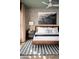 Stylish bedroom features a king-size bed, patterned wallpaper, and a large mountain landscape artwork at 8001 E Voltaire Ave, Scottsdale, AZ 85260